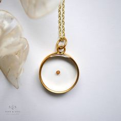 Our Deep Round Pendant has a nostalgic, classic feel. Available in 24k gold or .999 silver plated frame. Choose from a variety of meaningful botanicals. Daisy is a symbol of hope Thyme is a symbol of courage Rose is a classic symbol of love Queen Annes Lace is a symbol of sanctuary The Mustard Seed is a symbol of faith Pendant hangs from a gold or silver plated chain, plain or satellite, and available in 26" or 30" lengths. Model is wearing a 30" chain. Materials are tarnish resistant. However, Minimalist Gold Jewelry As Keepsake, Minimalist Gold Jewelry For Keepsake, Gold Minimalist Necklace For Keepsake, Gold Brass Jewelry With Pressed Flowers, Gold Spiritual Jewelry For Keepsake, Gold Jewelry With Birth Flower For Memorial, Gold Birth Flower Jewelry For Memorial, Minimalist Birth Flower Jewelry Keepsake, Memorial Gold Jewelry With Birth Flower