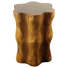 a wooden stool that has been carved into the shape of a tree stump with a circular top