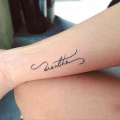 a woman with a tattoo on her arm that says,'little'in cursive writing