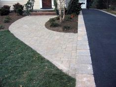 a house with a driveway and landscaping around it