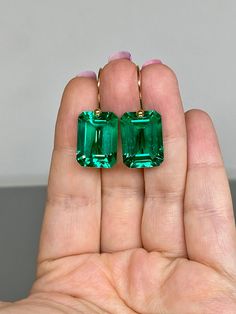 Beautiful Colombian emerald earrings in Brilliant drops. The faceted rectangle drops have a gorgeous Caribean ocean green color that brings lots of depth to the stone and reflects lights beautifully. The fancy drops are attached to 24K Gold Vermeil/ 14K Solid gold ear wires. The earrings are elegant, and minimalist, and have a lux look.  A truly gorgeous pair of earrings. When 14K SOLID GOLD ear wires are being used, the ear wire ends are hand-stamped as proof of being 14K solid gold. In addition, extra work was done at the end of the ear wires to prevent any sort of pain or injury while inserting them through the ear lobes. **The 14K WHITE solid gold ear wires are RHODIUM plated to prevent tarnish of the ear wires over time. * Quality: Superb AAA+ Flawless Faceted Colombian emerald  * Car Luxury Emerald Earrings In Emerald Cut, Formal Octagon Gemstone Earrings, Formal Baguette Cut Emerald Earrings, Formal Baguette-cut Emerald Earrings, Luxury Green Emerald-cut Earrings, Emerald Cut Gemstone Earrings For Formal Occasions, Fine Emerald Jewelry In Rectangular Shape, Elegant Octagon Gemstone Earrings, Rectangular Emerald Fine Jewelry