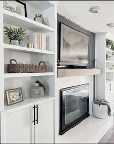 a living room filled with furniture and a fire place in front of a tv mounted on a wall