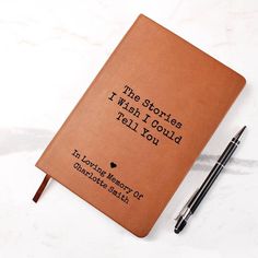 a brown notebook with writing on it and a pen next to it that says, the stories i wish i could tell you