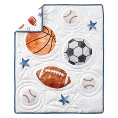 a quilted blanket with sports balls and stars on it