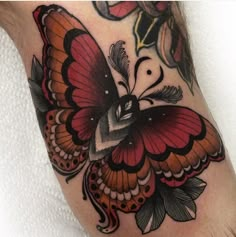 a colorful butterfly tattoo on the leg