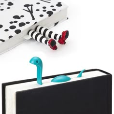 an open book with a toy flamingo sticking out of it