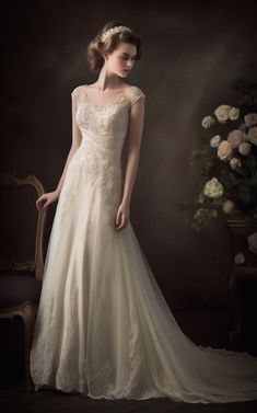 a woman in a wedding dress posing for the camera with her hand on her hip