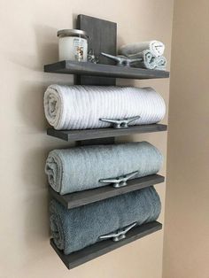 three shelves holding towels and other items in a bathroom