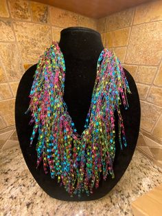 Scarf/Necklace  Colors:  Jasmine - beautiful "bright" shades of blues, pinks, greens & yellows. Check out my shop for many other colors.  If don't see a color, please ask🙂 Handmade, lightweight - made from ladder yarn (nylon & lurex) Approximately 68" in length. Can be worn as an Infinity (double loop), Pull-through  or just let it hang. Perfect item  to dress up any outfit. Unique Multicolor Summer Necklaces, Multicolor Fun Beaded Necklaces For Party, Fun Multicolor Beaded Necklaces For Parties, Fun Multicolor Beaded Necklace For Parties, Fun Multicolor Beaded Party Necklaces, Multicolor Multi-strand Necklace For Party, Funky Multicolor Festival Necklaces, Funky Multicolor Beaded Necklace, Ladder Yarn