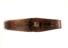 "This beautiful waist belt is made with a gorgeous semi- veg tanned leather. The material chosen is the best quality leather with a 3mm thickness.  It is sturdy, durable and will aged nicely. The belt is designed to fastened at the front. The buckle is 4.5 cm high and 7 cm long and antique brass finished for all colours. The front panel height is about 10cm, the side about 6cm and at the centre back it is about 5.5cm. It does varies tiny bit from size to size to keep the proportion. The sizes work as below. The measurements being taken at the natural waist which refers to the narrowest point between the bottom of the rib cage and the pelvis, about 1\" above the belly button. When you measure yourself make sure you allow breathing allowance. Choose your size: XS              63.5 - 68.5 cm Leather Corset Belt For Festivals, Adjustable Brown Corset Belt With Matching Belt, Vintage Brown Corset Belt For Festivals, Brown Leather Corset Belt With Removable Belt, Brown Corset Belt For Festivals, Vintage Brown Corset Belt With Belt Loops, Brown Leather Corset Belt For Festivals, Brown Leather Corset Belt, Cincher Belt