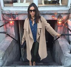 a woman standing in the entrance to a building