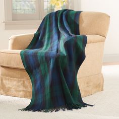 a plaid blanket draped over a couch in a living room