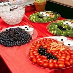 a table topped with lots of different types of vegetables and fruit on plates next to each other