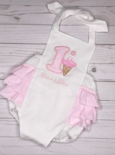 "Pretty pink and white seersucker and a sweet ice cream treat are perfect for your little one's 1st birthday! Personalize it with her name for free! This can also be done without a number. The pink rompers are also available in my shop. Available in sizes: newborn: baby's length 18-21.5\", chest 14-15\", finished length, top of bodice to crotch: 10\" 0-3 months: baby's length 21-23\", chest 16-17\", finished length, top of bodice to crotch: 11.5\" 3-6 months: baby's length 24-26\", chest 17-18\" Ice Cream 1st Birthday, Ice Cream Outfit, White Ice Cream, Elizabeth First, Birthday Ice Cream, Cream Outfit, Ice Cream Candy, Ice Cream Birthday