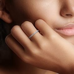 a close up of a woman wearing a diamond ring