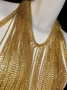 Love this necklace! Gold plated Strands of long champagne colored crystals. Can be worn as a necklace or choker. Always remember more is more! Elegant Gold Beaded Chain Necklace For Party, Gold Rhinestone Jewelry For Parties, Gold Fringed Long Necklace, Gold Crystal Rhinestone Necklace With Chain, Gold Fringe Long Necklace, Gold-tone Choker Chain Necklace For Party, Party Jewelry In Gold-tone With Gold Beads, Gold Crystal Backdrop Necklace With Adjustable Chain, Sparkling Choker Necklace For Party