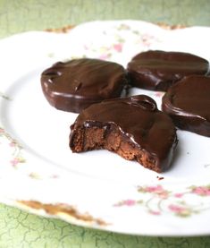 chocolate covered cookies on a plate with one broken in half