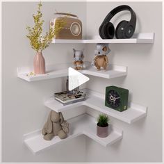 there are several shelves with various items on them, including headphones and an alarm clock