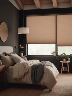 a bed sitting in a bedroom next to a window with blinds on it's side