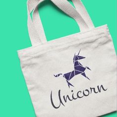 an unicorn bag with the word unicorn printed on it, against a green background