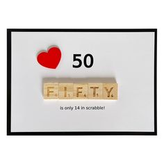 a wooden block with the word fifty on it and a red heart in the middle