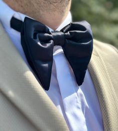 "Example Using Wedding as a Place: \"Imagine the grandeur of a majestic castle wedding, with you donning our navy, dark blue, and parlament blue butterfly bow tie. Its royal hues perfectly match the regal ambiance, making it the ideal accessory for a fairy tale wedding. Let your attire be as enchanting as the venue itself, creating timeless memories on your special day.\" 5 More Examples of Places and Weddings: 1- Beachfront Nuptials: Say \"I do\" by the sea, and let our elegant bow tie accentuate your beachfront wedding style. 2- Rustic Barn Wedding: Embrace the rustic charm of a barn wedding with our quality satin bow tie, a symbol of country elegance on your special day. 3- City Rooftop Wedding: For a modern and chic rooftop wedding, our butterfly bow tie adds a touch of sophistication Classic Wedding Suit And Tie Accessories With Satin Finish, Tuxedo Wedding Accessories With Satin Bow, Dapper Black Tuxedo For Wedding, Black Bow Tie For Wedding, Black Tuxedo With Ties For Wedding, Classic Black Bow Tie For Groom, Classic Black Wedding Suit And Tie Accessories, Classic Black Suit And Tie Accessories For Wedding, City Rooftop Wedding