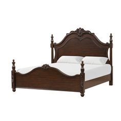 a wooden bed with white sheets and pillows