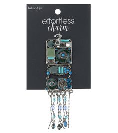 a cell phone charm with beads and chains hanging from it's front end in a package