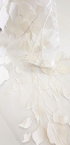 white fabric with leaves on it