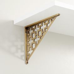 the corner of a shelf with a decorative design on it