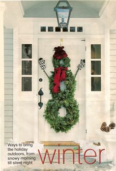 a wreath on the front door of a house with skis and poles attached to it