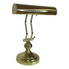 an antique brass desk lamp on a white background