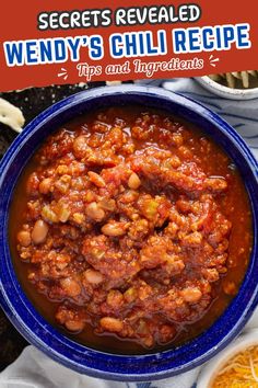 a blue bowl filled with chili and beans