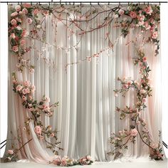 the curtain is decorated with pink flowers and greenery for an elegant wedding ceremony or special event