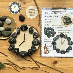 a wooden table topped with rocks covered in numbers next to a clock and other items