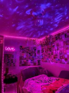 a bedroom with purple lights and pictures on the wall