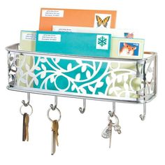 a metal shelf with keys and mail hanging from it's sides, filled with key holders