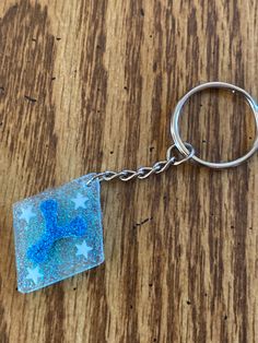 a glass keychain with a star design on it