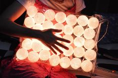 a person holding a box filled with lights