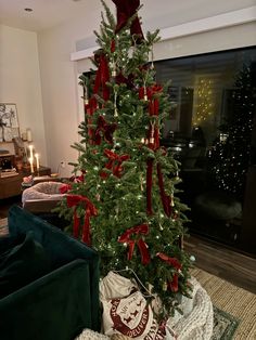 a christmas tree with red bows on it