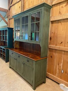 an old green cabinet is in the middle of a room