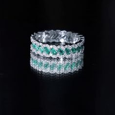 Product Details Delight in the enchanting allure of our Braided Ring, an irresistible accessory that will captivate your partners heart. This Wedding Band showcases Baguette Cut Created Emerald gemstones at its center, and the braided shank is adorned with the brilliance of Round Shape Moissanite, enhancing its beauty. Product Information SKU SHP-RINGS122036918 Width 2 mm Height 5 mm Weight 3.20 gm (Approximate) LAB CREATED EMERALD INFORMATION No.of Stones 22 Pieces Total Weight 1.32 Carat (Appr Green Cubic Zirconia Diamond Ring With Halo Design, Green Diamond Eternity Band With Prong Setting, Dazzling Green Diamond Cut Ring, Dazzling Green Diamond-cut Rings, Diamond White Half Eternity Emerald Cut Jewelry, Elegant Emerald Eternity Band With Prong Setting, Elegant Eternity Band For May Birthstone, Elegant Round Cut Emerald Eternity Band, Silver Emerald Jewelry With Halo Detail