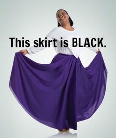 a woman in a long purple skirt with the words this shirt is black on it