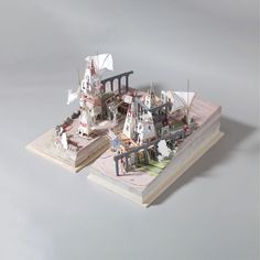 a paper model of a city with lots of buildings and people walking around the area