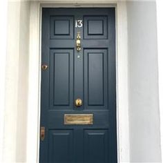 a blue front door with gold trim and number 13 on the bottom part of it