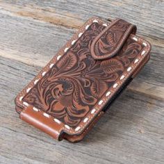 a brown leather wallet sitting on top of a wooden table