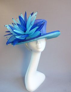 Made with pure love this sinamay hat in kingfiher and royal blue with ton sur ton grinn adorment siz Blue Top Hat With Curved Brim For Formal Occasions, Blue Curved Brim Top Hat For Formal Occasions, Blue Sinamay Hat For Party, Blue Brimmed Mini Hats For Royal Ascot, Blue Brimmed Mini Hat For Races, Blue Sinamay Fascinator For Party, Blue Brimmed Fascinator For Royal Ascot, Blue Sinamay Party Fascinator, Elegant Handmade Blue Hats