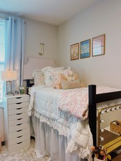 a white bed sitting next to a window in a bedroom