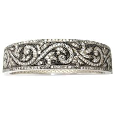 This beautiful sterling silver bangle bracelet is hand engraved with an elegant and ornate scroll design set with 3.50 carats of brilliant, sparkling diamonds! The stippled, blackened background showcases the intricate diamond-studded details, highlighting the rich silver tones. Fine metalwork on the inside of the bangle adds a decorative element while making the bracelet even more comfortable to wear. A lavish, old-world feel, displaying wonderfully modern craftsmanship! 18k Gold Bracelet, Silver Bangle Bracelet, Artisan Bracelets, Sterling Silver Bangle Bracelets, Vintage Bangles, Diamond Bangles Bracelet, Enamel Bangle, Sterling Silver Bangle, Gold Bracelet Cuff