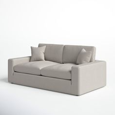 a white couch with two pillows on it